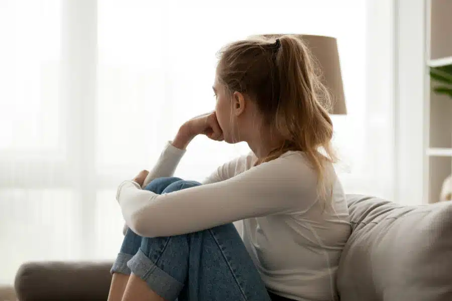 Woman looks out a window.
