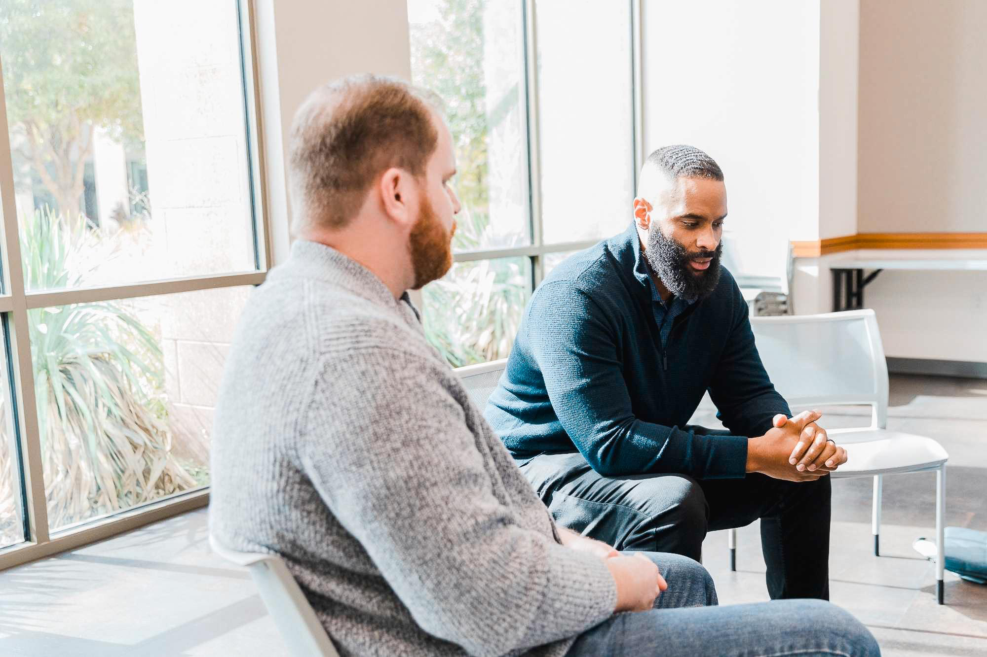 men speaking in a group session