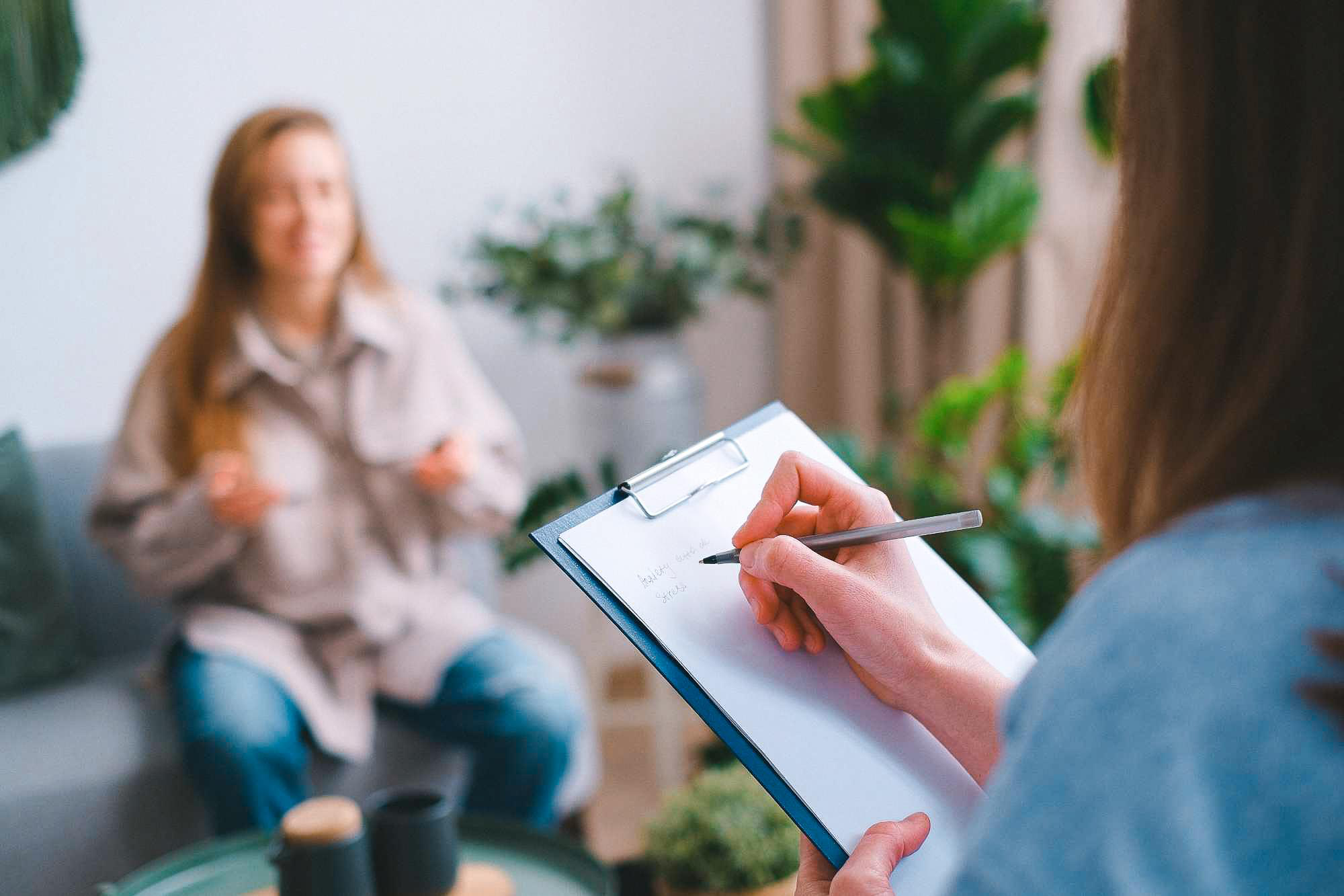 Therapist taking notes during a session